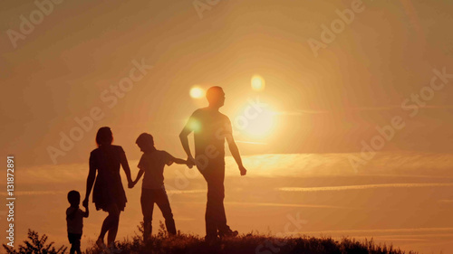 happy family at sunset silhouette of the water