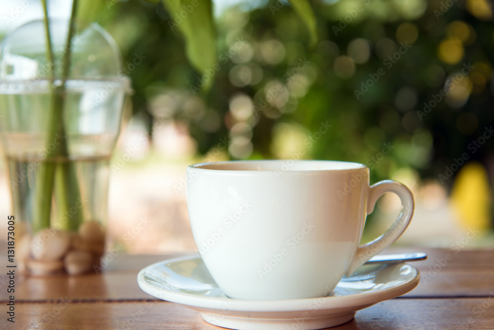 Fototapeta premium cup of fresh coffee with coffee beans on wooden table