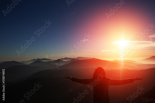 Woman on top of mountain. Trip concept.