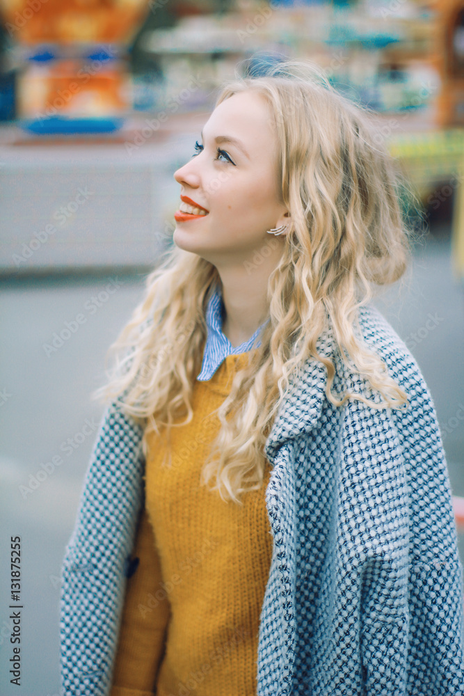 portrait of a happy young blonde girl in the amusement park, she look happy portrait of a happy young blonde girl in the amusement park, she look happy