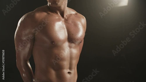 Healthy young man breathing and showing his chest muscles