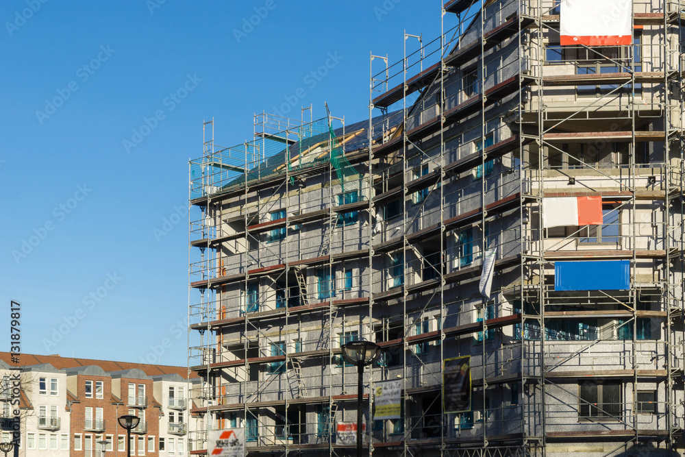 Baustelle eines Mehrfamilienhause mit Baugerüst Baustelle eines Mehrfamilienhause mit Baugerüst