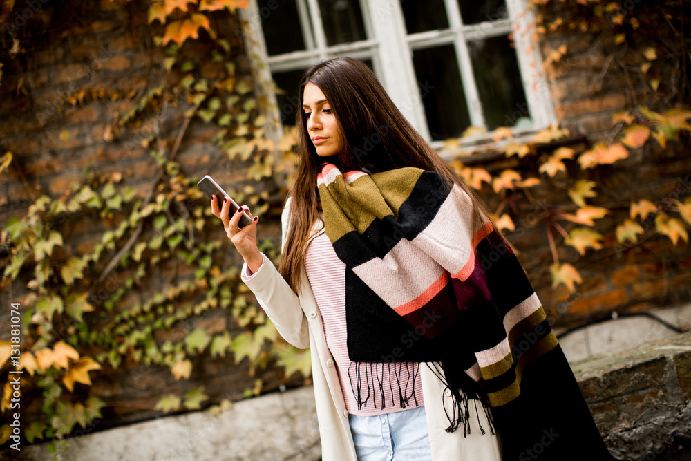 Pretty young woman on the city street with mobile phone Pretty young woman on the city street with mobile phone