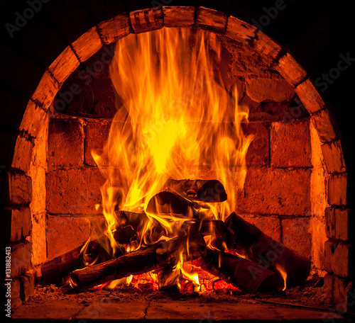 A fire burns in a fireplace