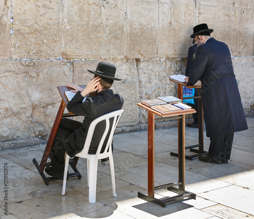 JERUSALEM, ISRAEL - MAY 26: Jews pray at the holy site. The Western Wall is the most sacred sites in Judaism, it attracts thousands of devotees every day, on May 26, 2013 in Jerusalem photo