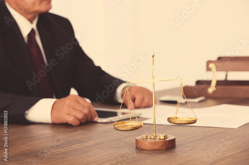 Scales of justice on wooden...
