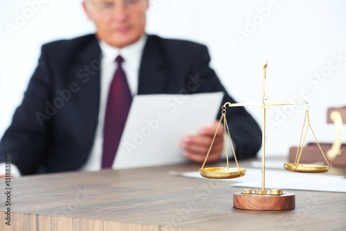 Scales of justice on wooden...