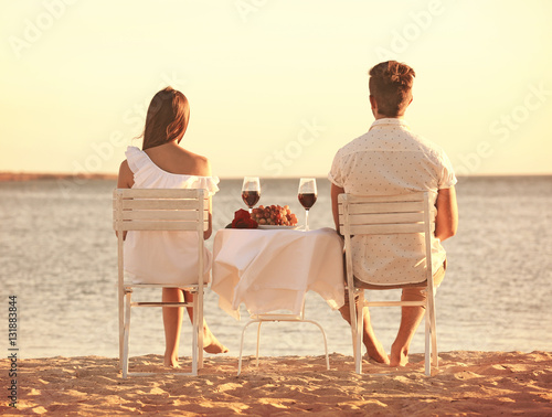 Young couple with wine havi...