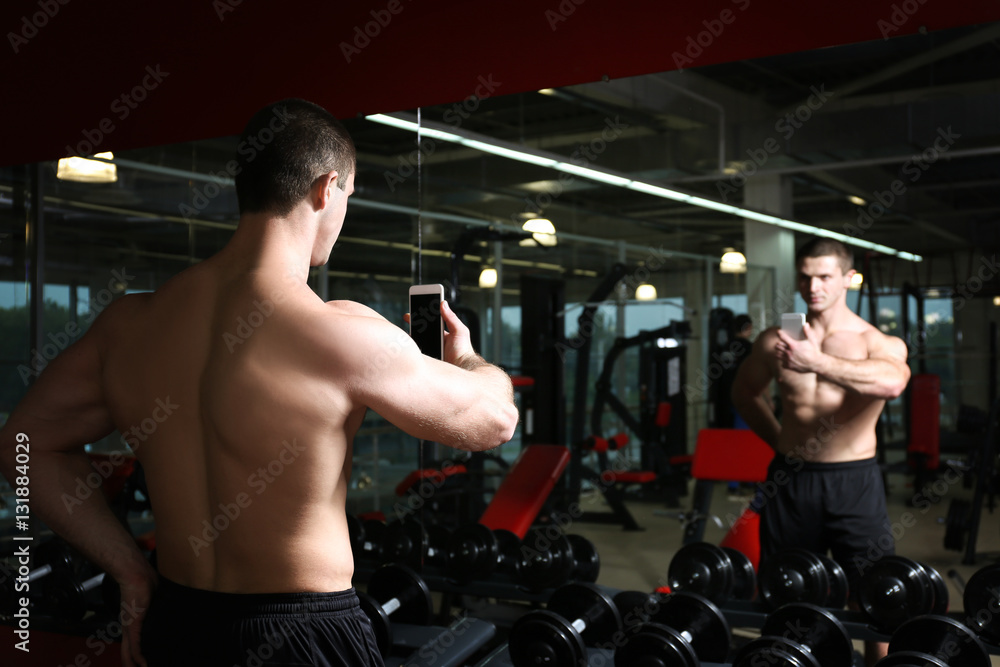 Young handsome man taking selfie in gym Young handsome man taking selfie in gym