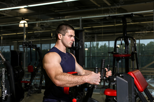 Young handsome man training in gym