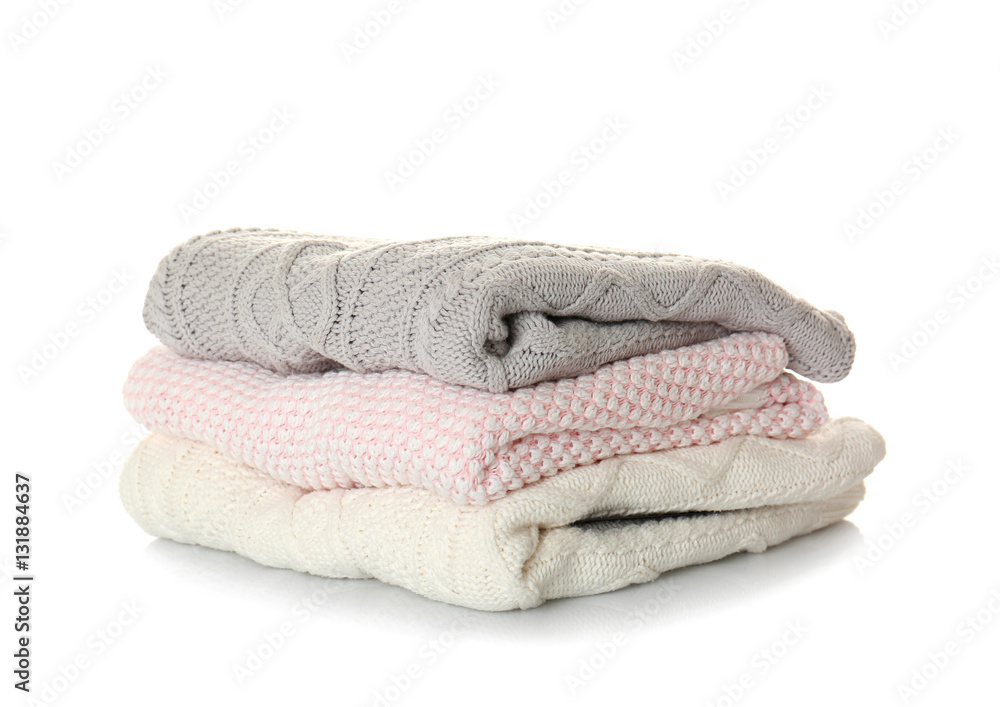 Stack of warm winter clothes on white background Stack of warm winter clothes on white background