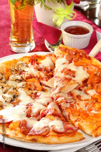 Pepperoni pizza with hot sauce and beer