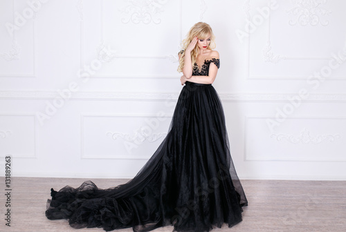 Beautiful blonde girl in a long black dress