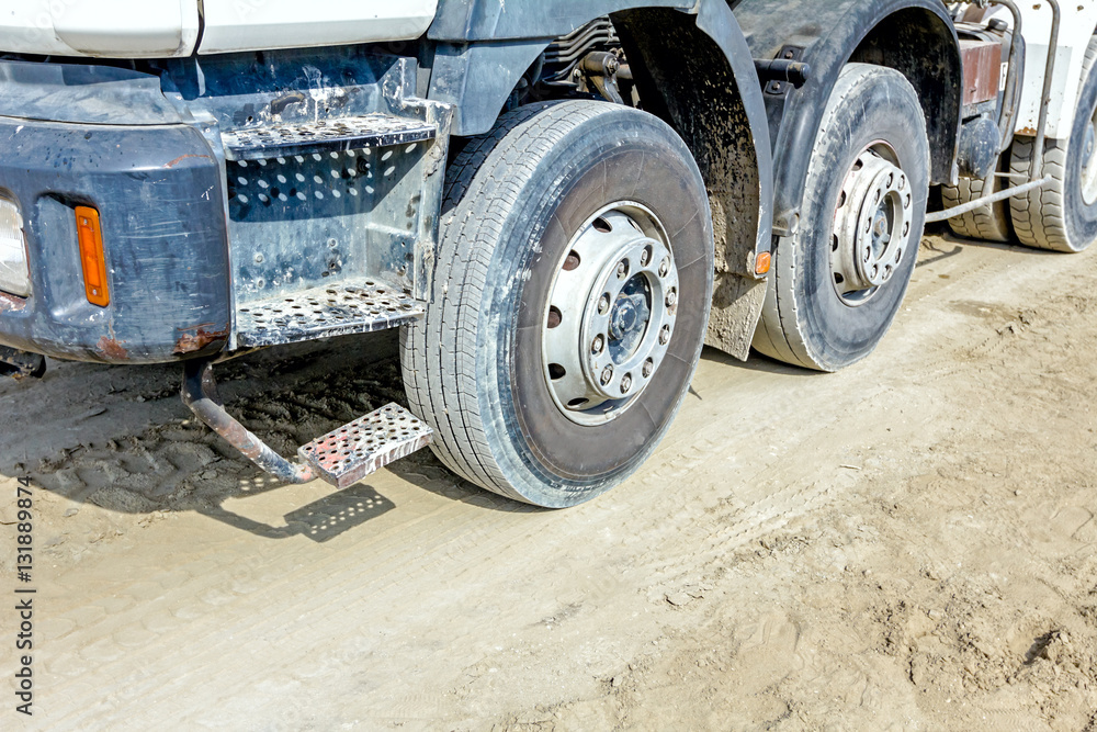 Steps on the side of a truck and undercarriage wheel