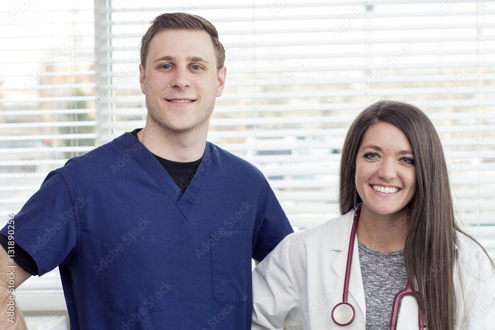 female doctor smiling next to white male nurse female doctor smiling next to white male nurse