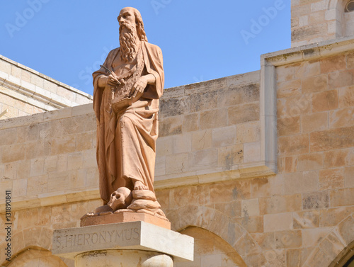 Saint Jerome lived in Bethlehem from about 384 to 420 A.D. In the front of the Church of St. Catherine in Bethlehem there is a modern statue of Jerome showing him.  photo