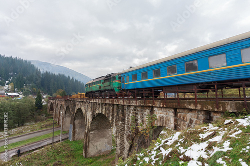 Diesel train traveling on the viaduct. Vorokhta, Ukraine