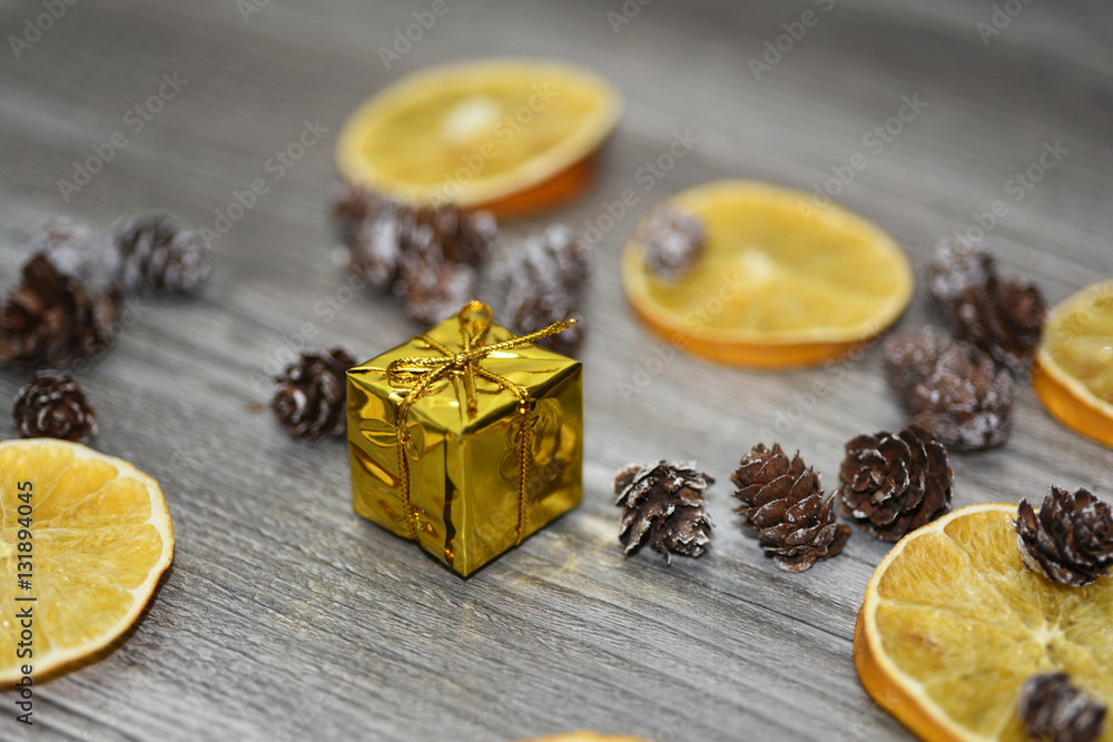 Small golden present with decorative cones Small golden present with decorative cones