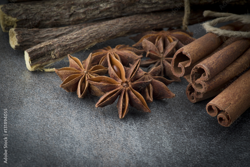 Star anise,cinnamon and licorice on grey background Star anise,cinnamon and licorice on grey background