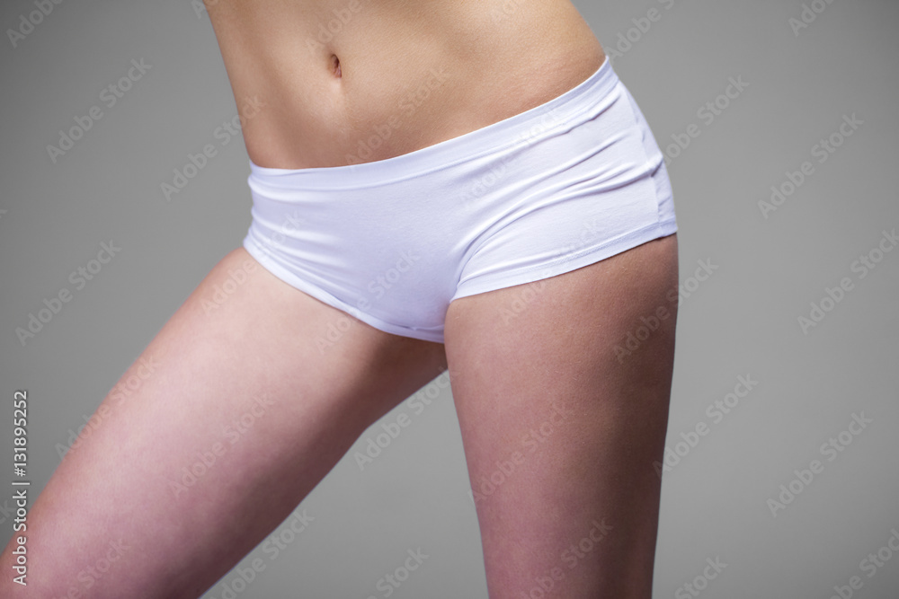 Close up photo of white womens drawers and slim belly Close up photo of white womens drawers and slim belly