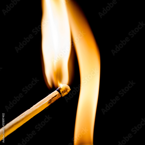 Used match and flame with black background