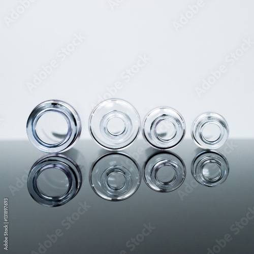 Small glass bottles with reflexions