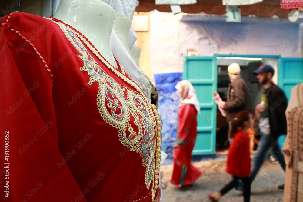 Traditional Arab dress and in the background unrecognizable people