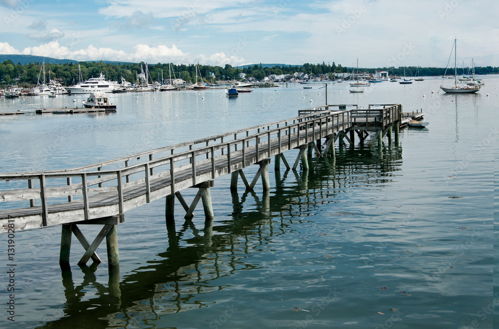 Long Pier: A wooden walkway extends far across the shallow end of a bay in Maine.
Long Pier: A wooden walkway extends far across the shallow end of a bay in Maine.