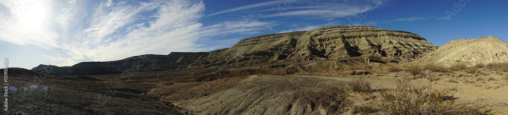 a butte is featured in a desert panorama. a butte is featured in a desert panorama.