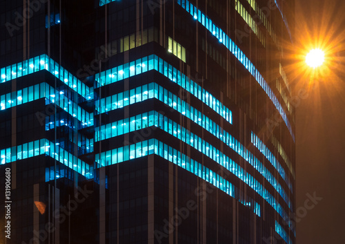 Photography Modern office windows of skyscraper glowing at night