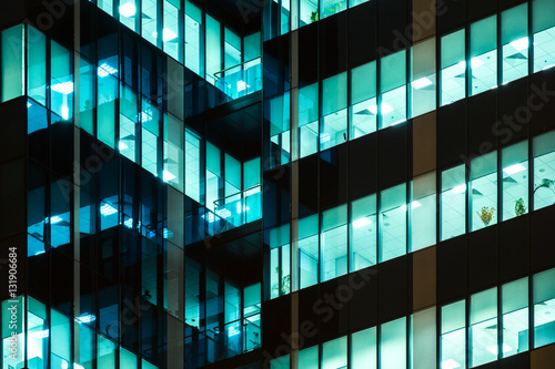 Photography Modern office windows of skyscraper glowing at night
