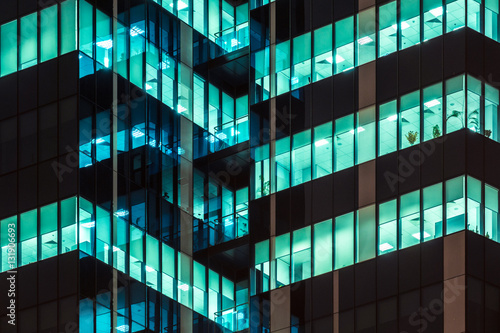 Photography Modern office windows of skyscraper glowing at night