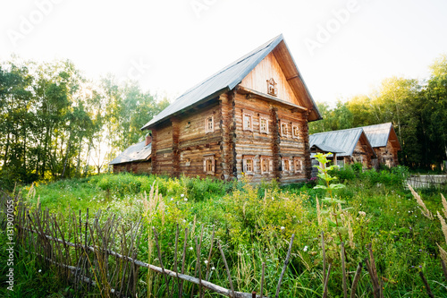 Classic Russian log house from among the green grass