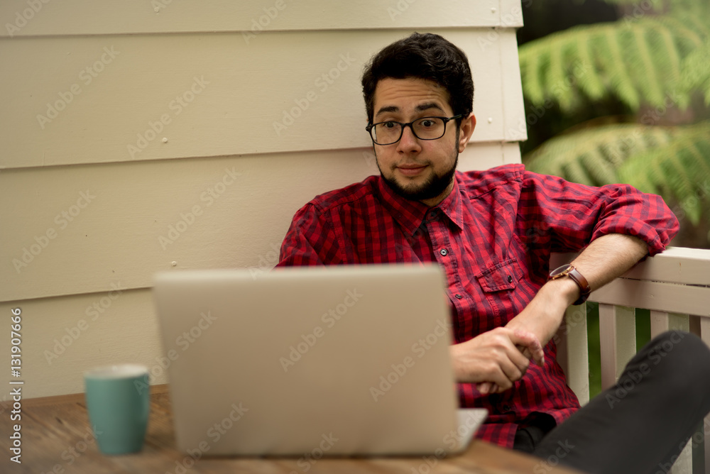 Young man with a laptop and smartphone sitting outdoor Young man with a laptop and smartphone sitting outdoor