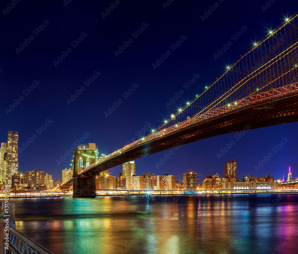 New York City Manhattan Bridge over Hudson River with skyline after sunset night view illuminated  l