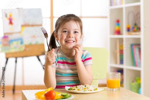 child little girl with fork...