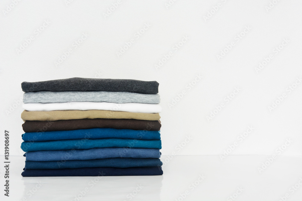 stack of t-shirt on white background, copy space