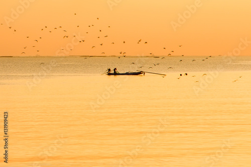 Silhouette Thai Fisherman going on ocean on traditional fishing