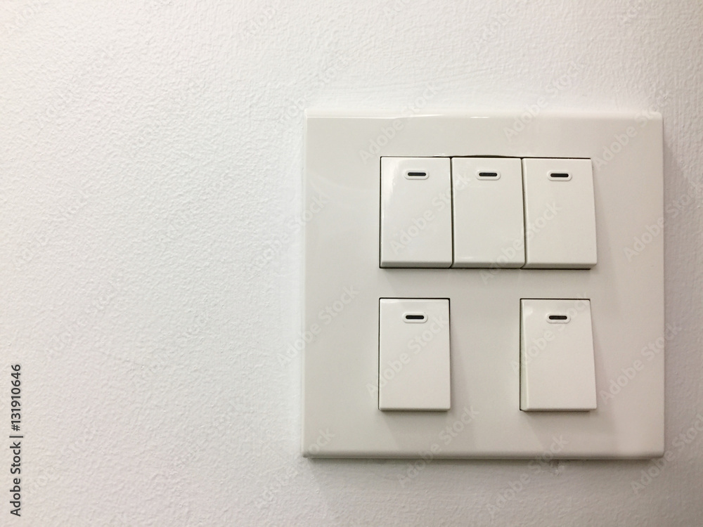 Light switches on white wall background Light switches on white wall background