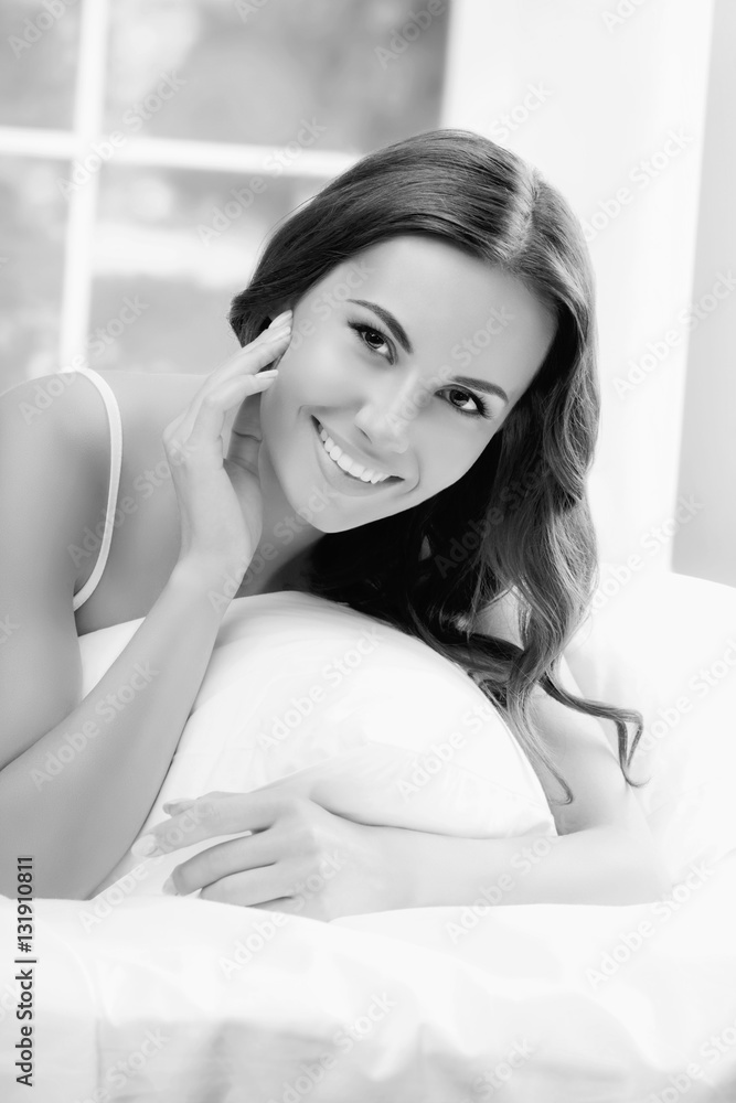 Young beautiful smiling woman waking up with pillow, at bedroom Young beautiful smiling woman waking up with pillow, at bedroom