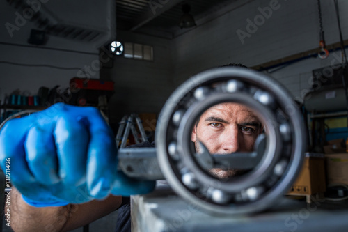Mechanic fixing a compressor engine photo