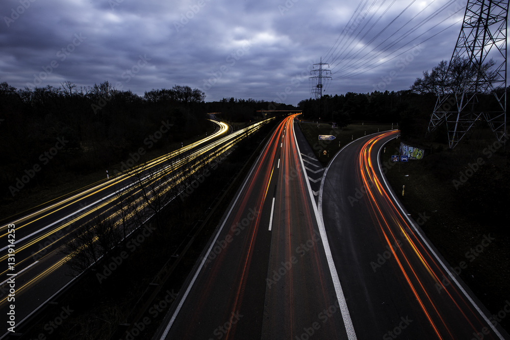Lichtspuren vorbeifahrender Autos auf der Autobahn A643 bei Mainz in der Nacht