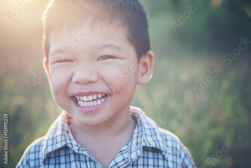 Canvastavla Close up of cute asian boy playing and smiling outdoors. Cute li