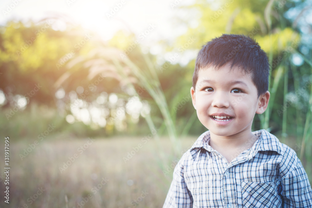 Close up of cute asian boy playing and smiling outdoors Close up of cute asian boy playing and smiling outdoors