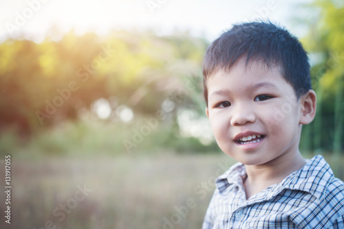 Close up of cute asian boy playing and smiling outdoors