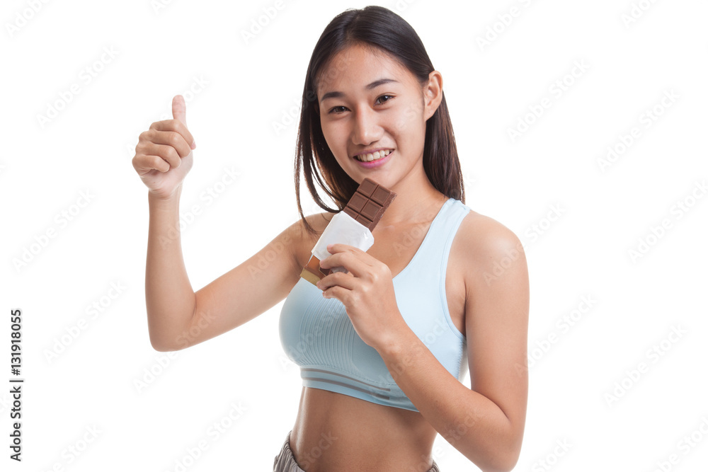 Beautiful healthy Asian girl thumbs up with chocolate. Beautiful healthy Asian girl thumbs up with chocolate.