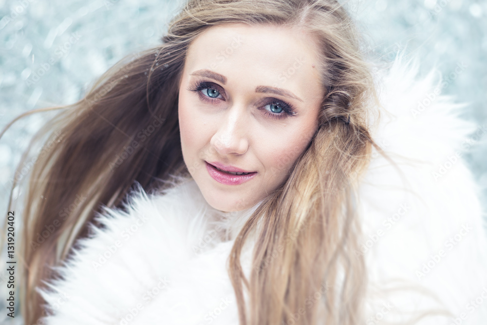 Young woman in white fur coat against wall of shattered mirrors. Young woman in white fur coat against wall of shattered mirrors.