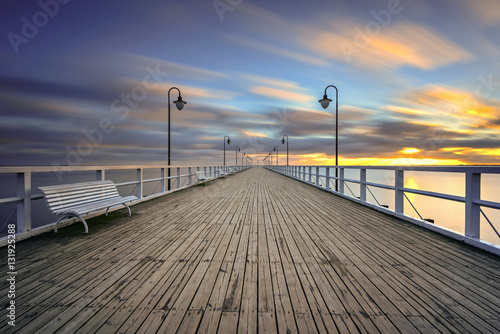 Wooden pier in Gdynia Orlowo in the morning with colors of sunrise. Poland. Europe. © vivoo