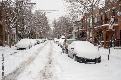 Street in Montreal's Plateau Neighbourhood with cars covered in snow