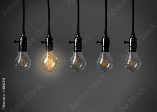 Light bulbs on gray background. Individuality concept